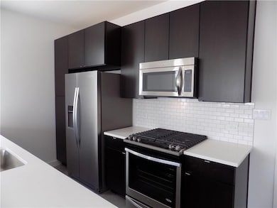 Kitchen with stainless steel appliances, light co