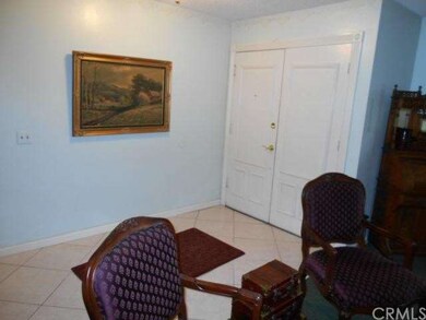 Entry with large tile flooring and double doors in