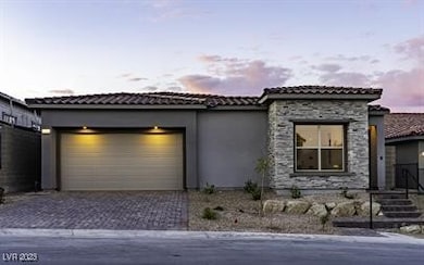 View of front of home with decorative driveway, st