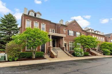 View of front of home with brick siding and a chimney