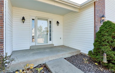Entrance to property featuring brick siding