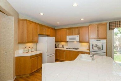 Clean open kitchen with dual ovens.