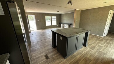 Kitchen with light wood finished floors, open floo