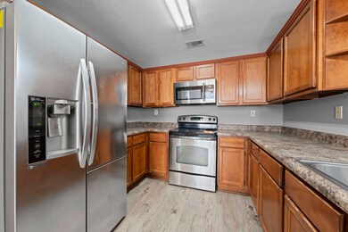 This eat-in kitchen offers style and convenience with stainless steel appliances, modern finishes, and room for casual dining.