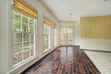 Back hall open to dining room with views of backyard and patio area.