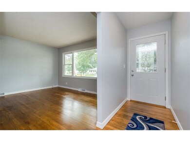 Entryway and living room original hardwood floors.