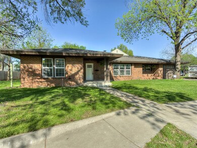 Single story home featuring a front lawn and brick