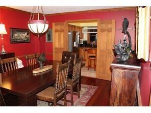 The dining room features crown moulding, chair rai