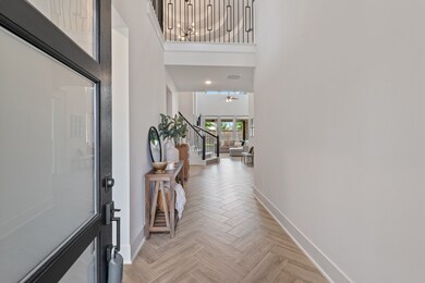 Discover a bright, spacious entryway with high cei