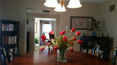 View from dining room towards foyer. Newer lighting fixtures.