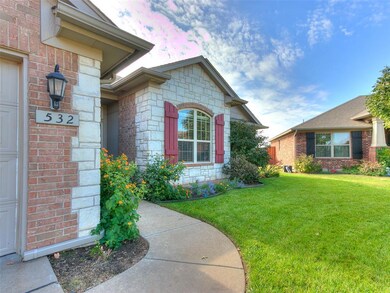 Property entrance featuring a yard and a garage