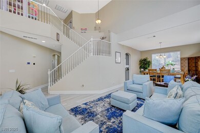 Living room with visible vents, arched walkways, w