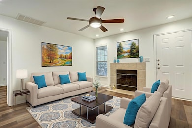 Living area featuring wood finished floors, reces
