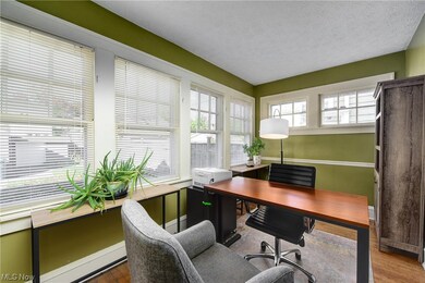 Home office with dark hardwood / wood-style flooring and a textured ceiling