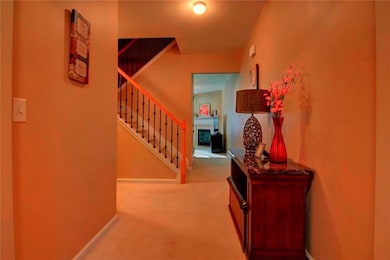 Hallway featuring carpet floors, stairway, and bas