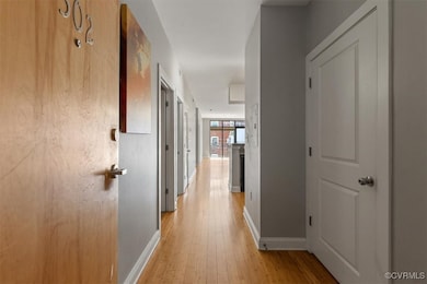 Hallway with baseboards and light wood finished fl