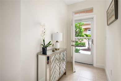 Doorway to outside with tile patterned floors and baseboards