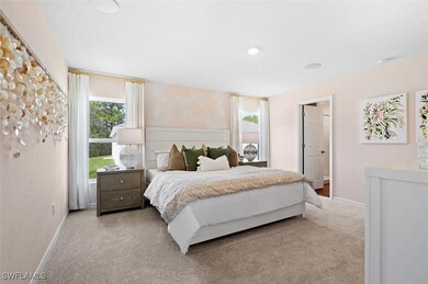 Carpeted bedroom with multiple windows and wallpap