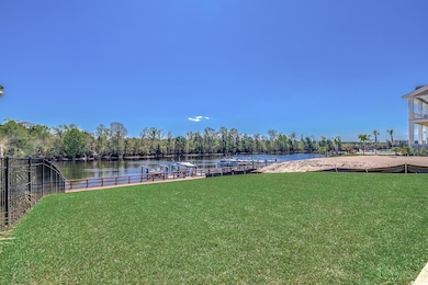 View of yard featuring a water view and a dock