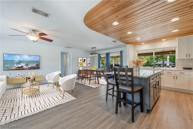 Kitchen featuring backsplash, hanging light fixtur