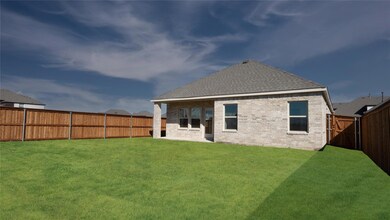 Rear view of house featuring a yard