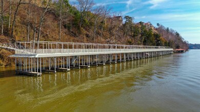 Dock area featuring a water view and a wooded view