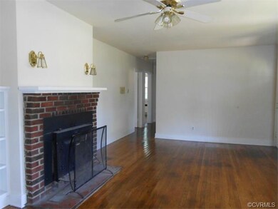 Brick fireplace and wall sconces and ceiling fan a