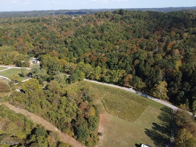 View of property location featuring a forest