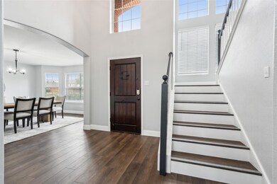Entrance foyer featuring a chandelier and dark har