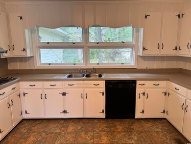 Kitchen featuring white cabinets, dishwasher, and 