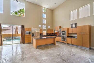 Kitchen featuring a towering ceiling, built in app