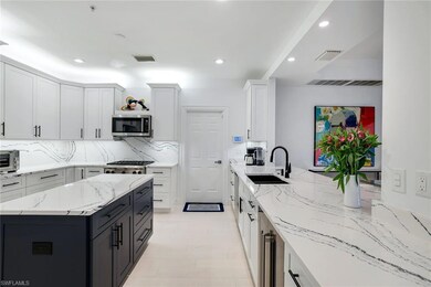 Kitchen featuring white cabinetry, sink, light sto