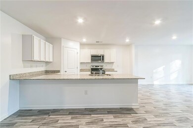 Kitchen featuring kitchen peninsula, appliances wi
