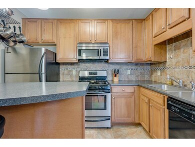 Updated kitchen featuring neutral tile flooring an
