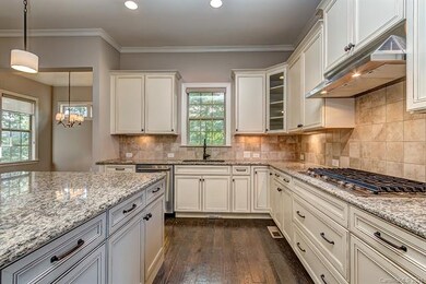 Gas cooktop vents outside and sink overlooks the p