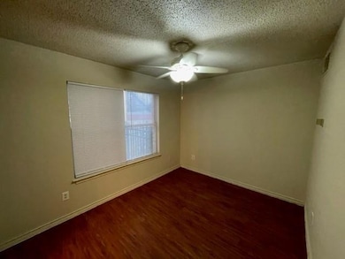 Unfurnished room with baseboards, a ceiling fan, 