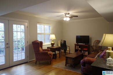 French doors lead to expansive deck overlooking ba