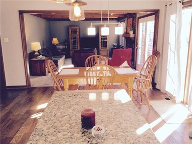 A view of how large the kitchen is providing a Dining Area and Huge Family Room with a Fireplace .. All the comforts and updates already done for your enjoyment.