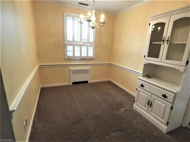 Lovely dining room with a built-in China cabinet and chandelier.