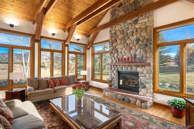 A massive river rock fireplace is the center piece of the great room, creating an inviting atmosphere.
