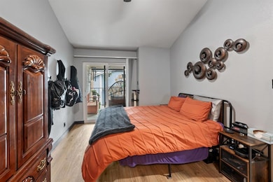 Bedroom with lofted ceiling, access to exterior, 
