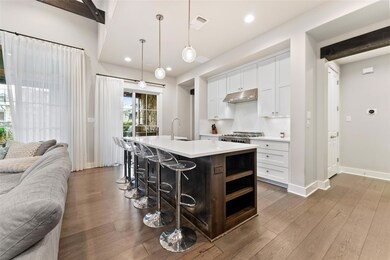 Kitchen featuring a sink, open floor plan, light 