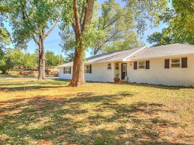 Ranch-style home featuring a front yard and brick siding