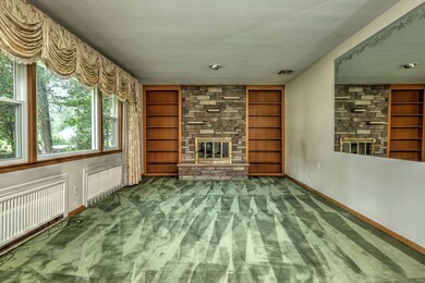 The large windows brighten up the Living Room complete with fireplace, even on a cloudy day.