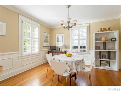 Formal dining room with wood floor, wainscoting, c