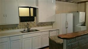 Kitchen featuring a sink and light countertops
