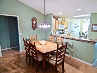 Dining Area with Laminate Flooring and Volume Ceil