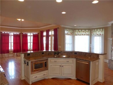 The kitchen island is complete with an undermount sink, built in microwave, and dishwasher. 