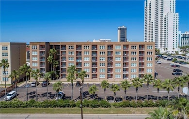 View of property with a view of city and uncovered parking