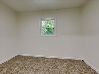 Spare room with carpet flooring and baseboards